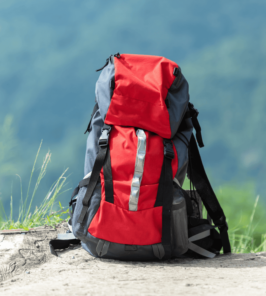 Vibrant woman in red dress admiring iconic white and blue Greek island architecture with a straw hat.
