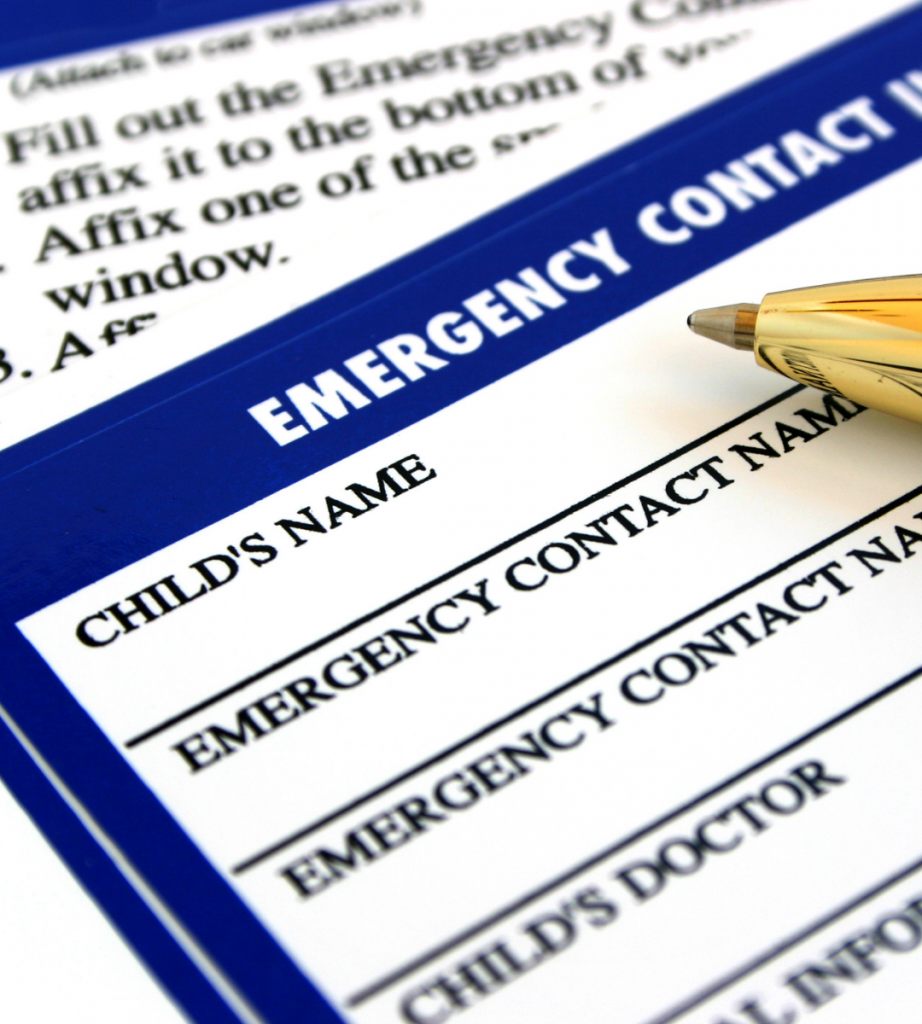 Vibrant woman in red dress admiring iconic white and blue Greek island architecture with a straw hat.